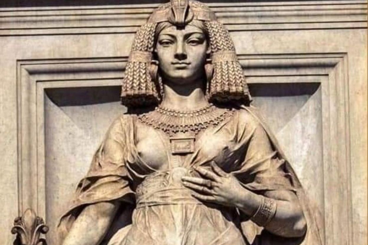 Cleopatra statue from Cairo Museum showing ancient Egyptian queen with cobra crown and royal regalia symbolizing divine power and sacred feminine authority