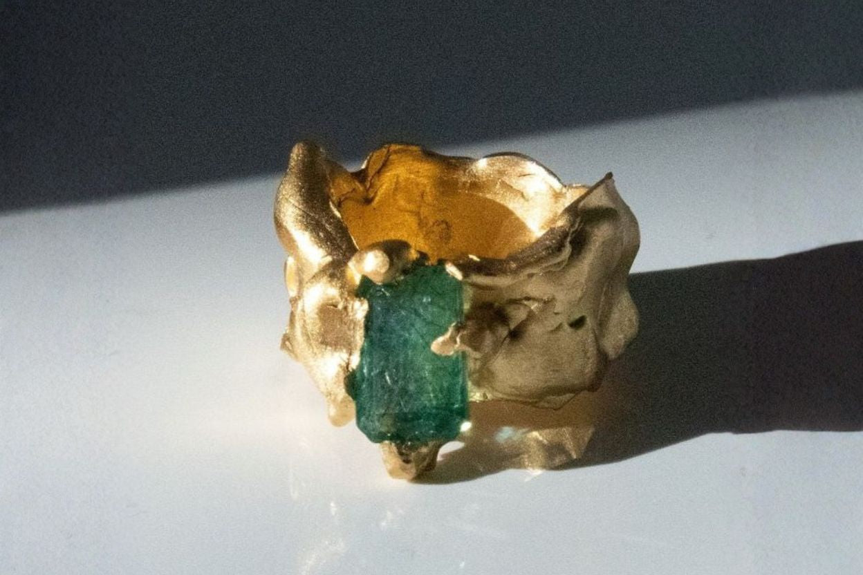 The Bow Jewelry emerald collection — matte gold and natural emerald ring inspired by feminine renewal and ancient mythology