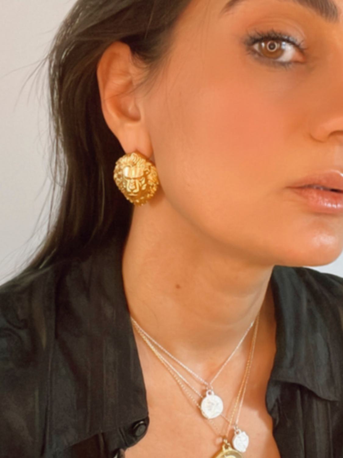 model wearing protector lion symbolic earrings | The Bow Jewelry