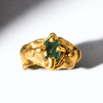 Gold ring with a emerald gemstone on a white background - The Bow Jewelry