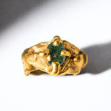 Gold ring with a emerald gemstone on a white background - The Bow Jewelry