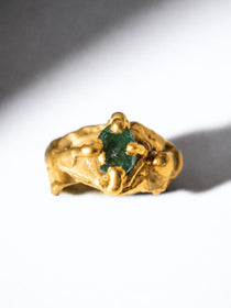 Gold ring with a emerald gemstone on a white background - The Bow Jewelry