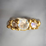 Gold ring with three moonstones on a gray background | The Bow Jewelry