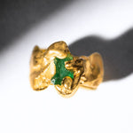 Gold ring with a emerald gemstone on a white background - The Bow Jewelry
