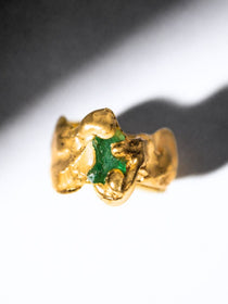 Gold ring with a emerald gemstone on a white background - The Bow Jewelry