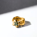 Gold ring with a emerald gemstone on a white background - The Bow Jewelry