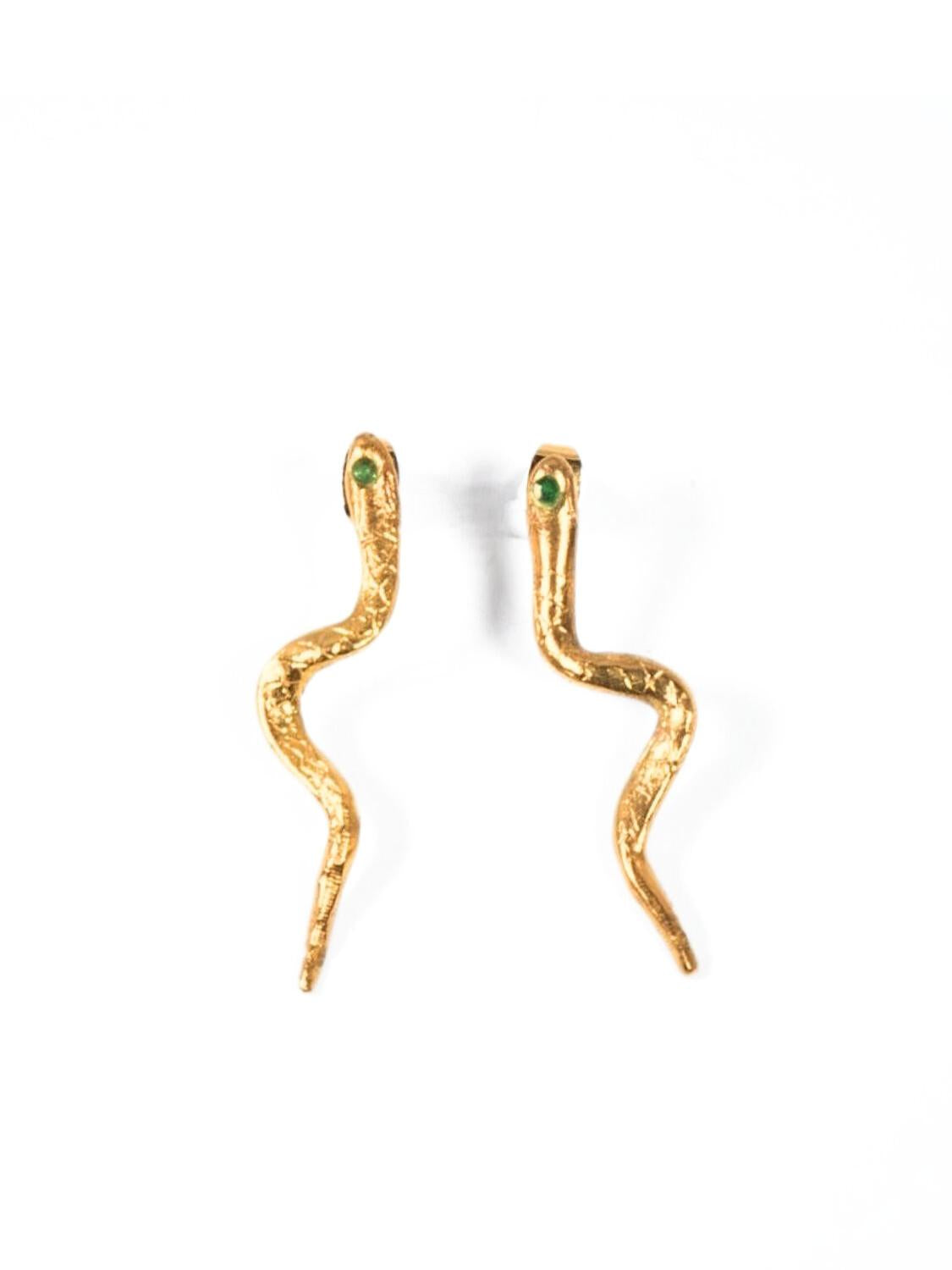 Gold snake-shaped earrings with emerald gemstones on a white background | The Bow Jewelry