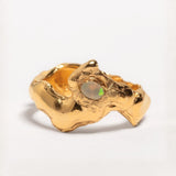 A gold-plated band ring with a faceted natural fire opal gemstone set in the center, displayed on a plain background | The Bow Jewelry