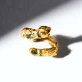 Gold snake shaped ring with two emerald gemstones on a white background - The Bow Jewelry