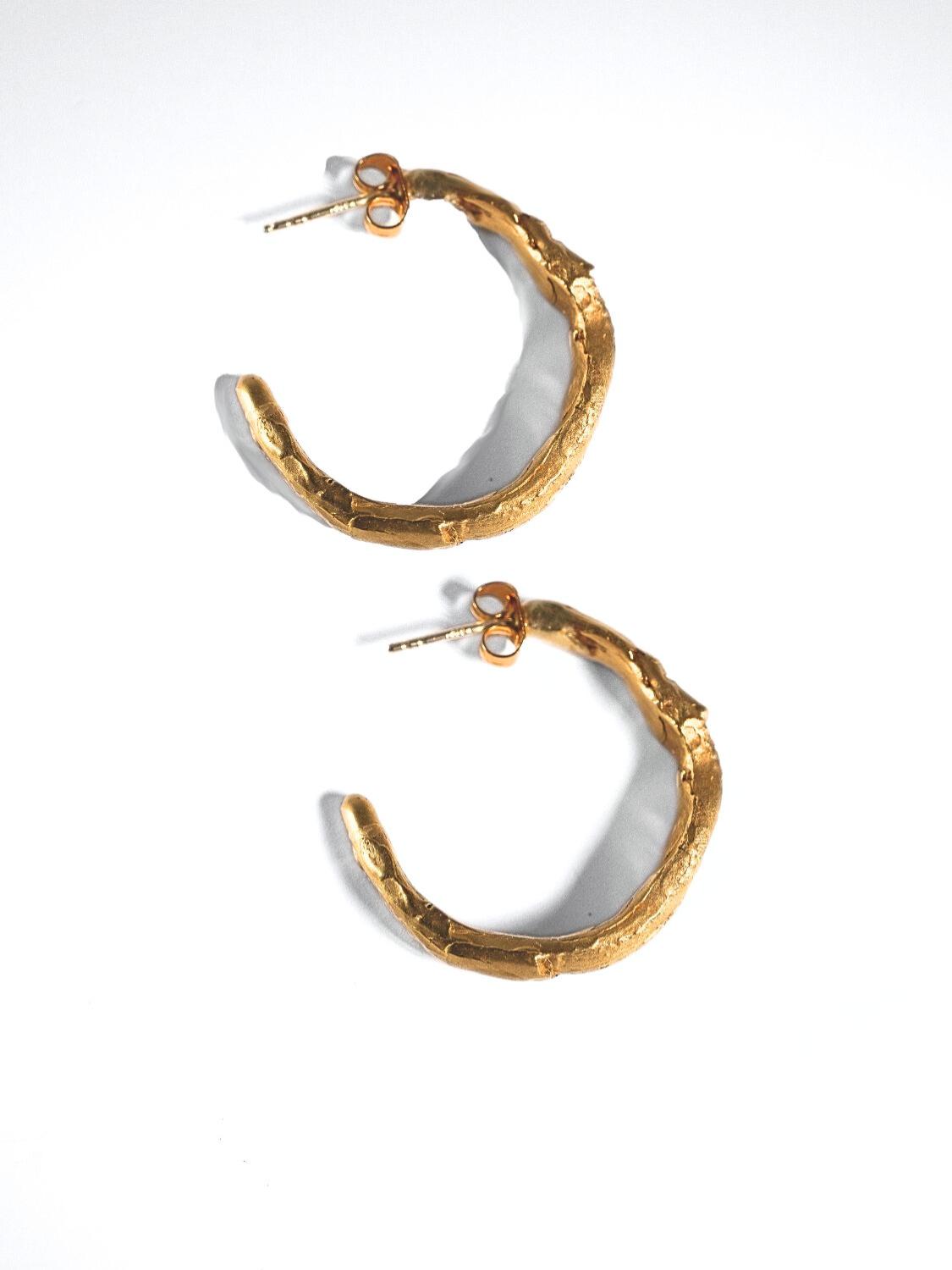 Gold hoop earrings on a white background