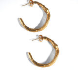 Gold hoop earrings on a white background