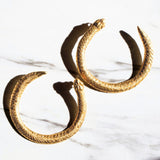 Gold Serpent Ouroboros hoop earrings on a white marble surface | The Bow Jewelry