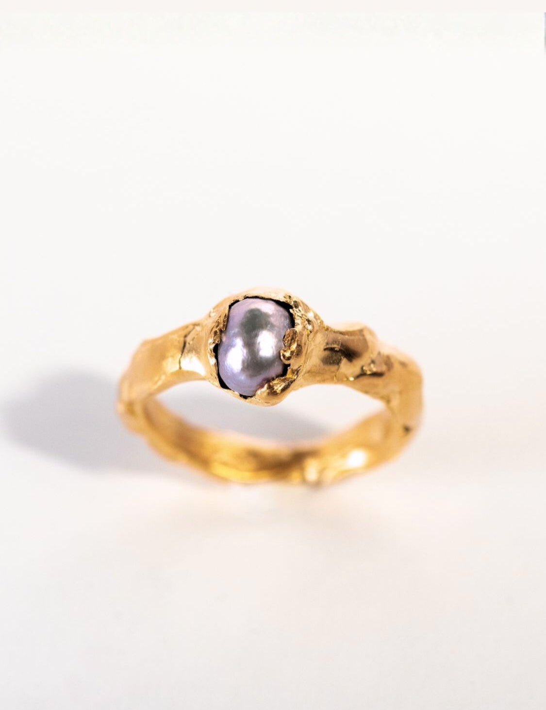 Gold ring with a grey pearl on a white background | The Bow Jewelry