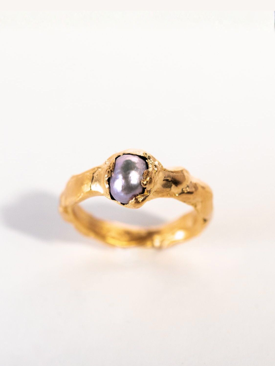 Gold ring with a grey pearl on a white background | The Bow Jewelry