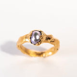 Gold ring with a grey pearl on a white background | The Bow Jewelry