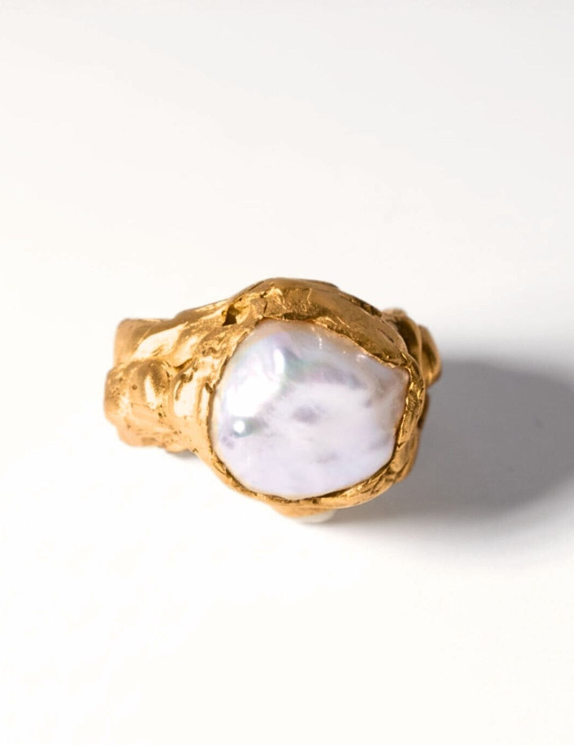 Gold ring with a large pearl on a white background | The Bow Jewelry