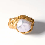 Gold ring with a large pearl on a white background | The Bow Jewelry
