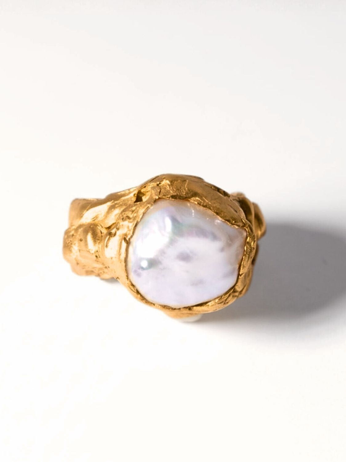 Gold ring with a large pearl on a white background | The Bow Jewelry