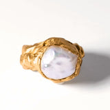 Gold ring with a large pearl on a white background | The Bow Jewelry