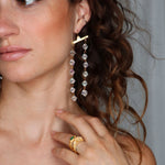Model wearing Fatale gold and crystal earrings | The Bow Jewelry