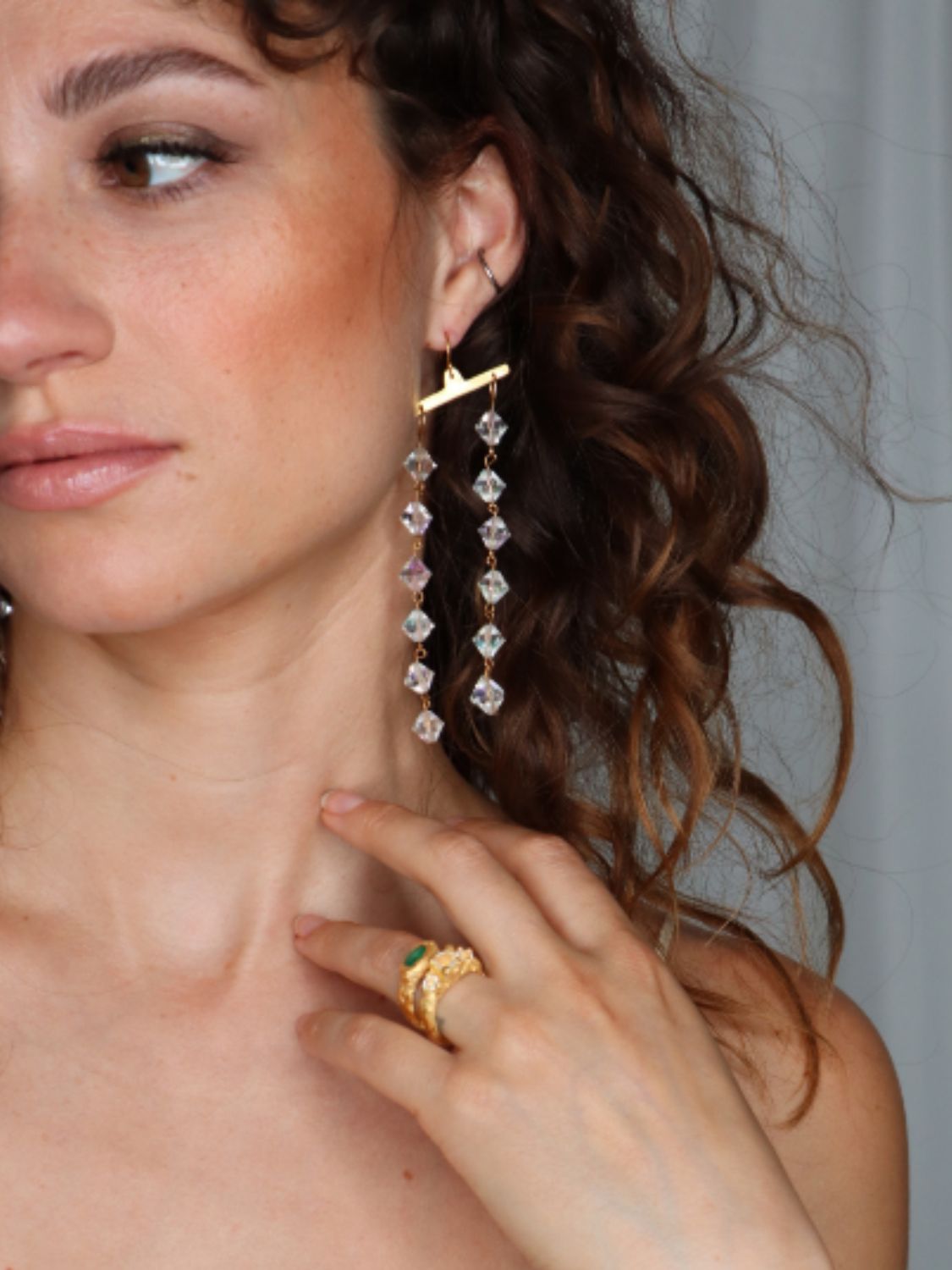Model wearing Fatale gold and crystal earrings | The Bow Jewelry