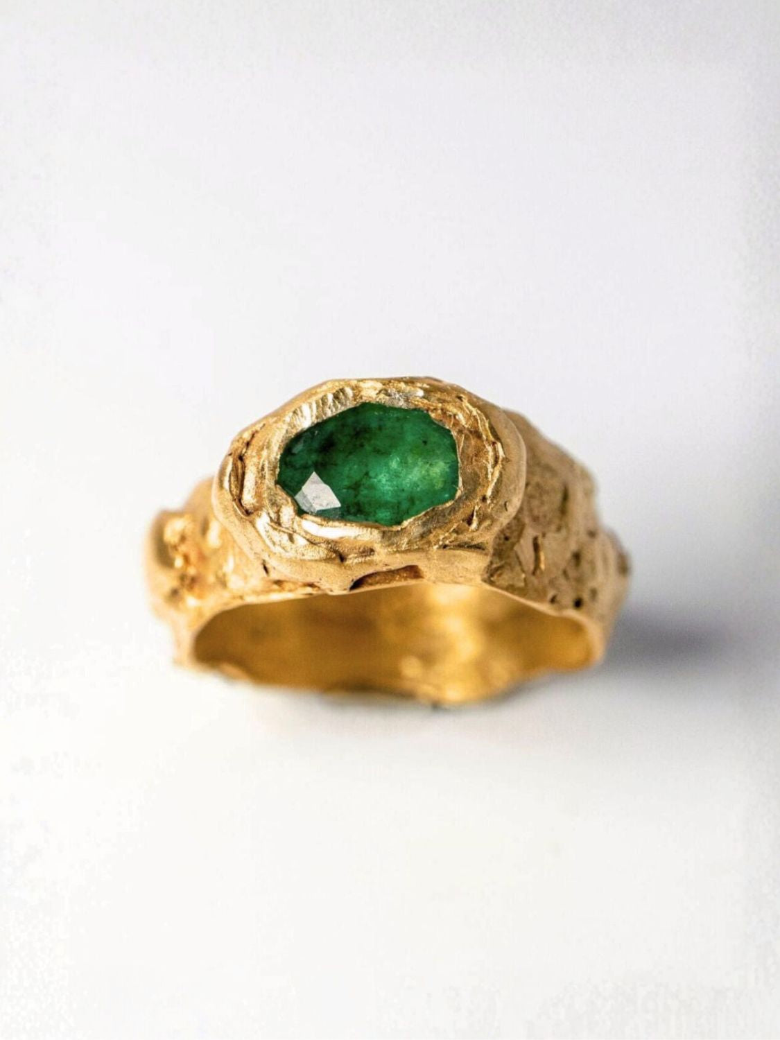 Gold ring with oval emerald on a white background  | The Bow Jewelry