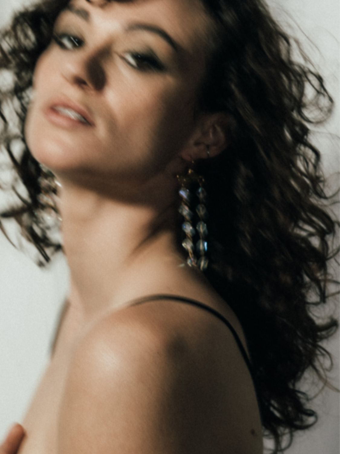 Model wearing Fatale gold and crystal earrings | The Bow Jewelry