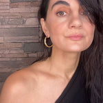 Woman wearing gold Sculptural Goddess hoop earrings | The Bow Jewelry