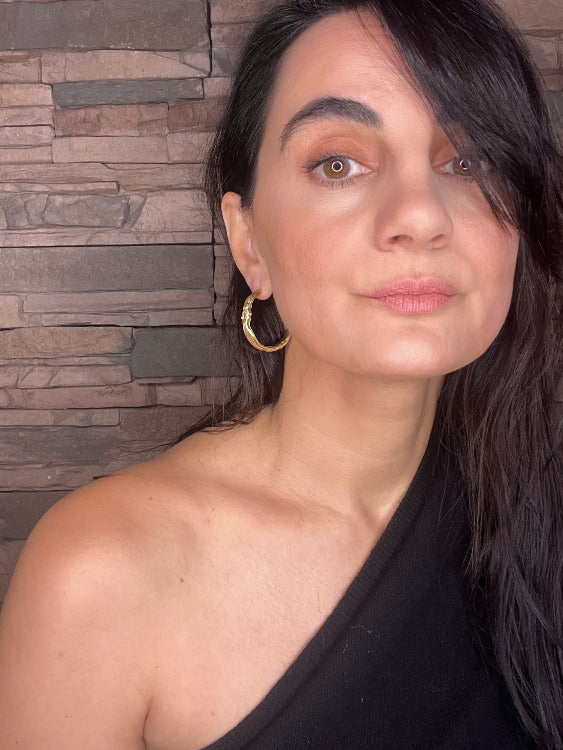 Woman wearing gold Sculptural Goddess hoop earrings | The Bow Jewelry