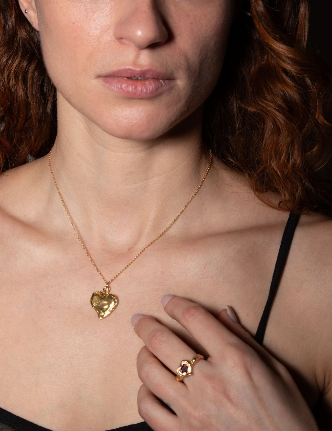 Model wearing a Brazen gold-plated heart pendant necklace with a matching ring | The Bow Jewelry