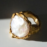 Gold ring with a large pearl on a dark background | The Bow Jewelry