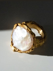 Gold ring with a large pearl on a dark background | The Bow Jewelry