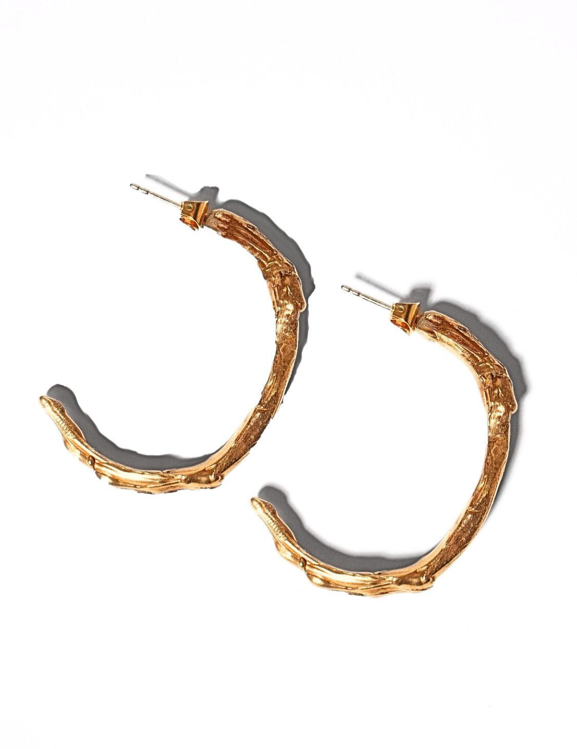 Gold goddess hoops on a light grey background | The Bow Jewelry