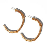 Gold goddess hoops on a light grey background | The Bow Jewelry