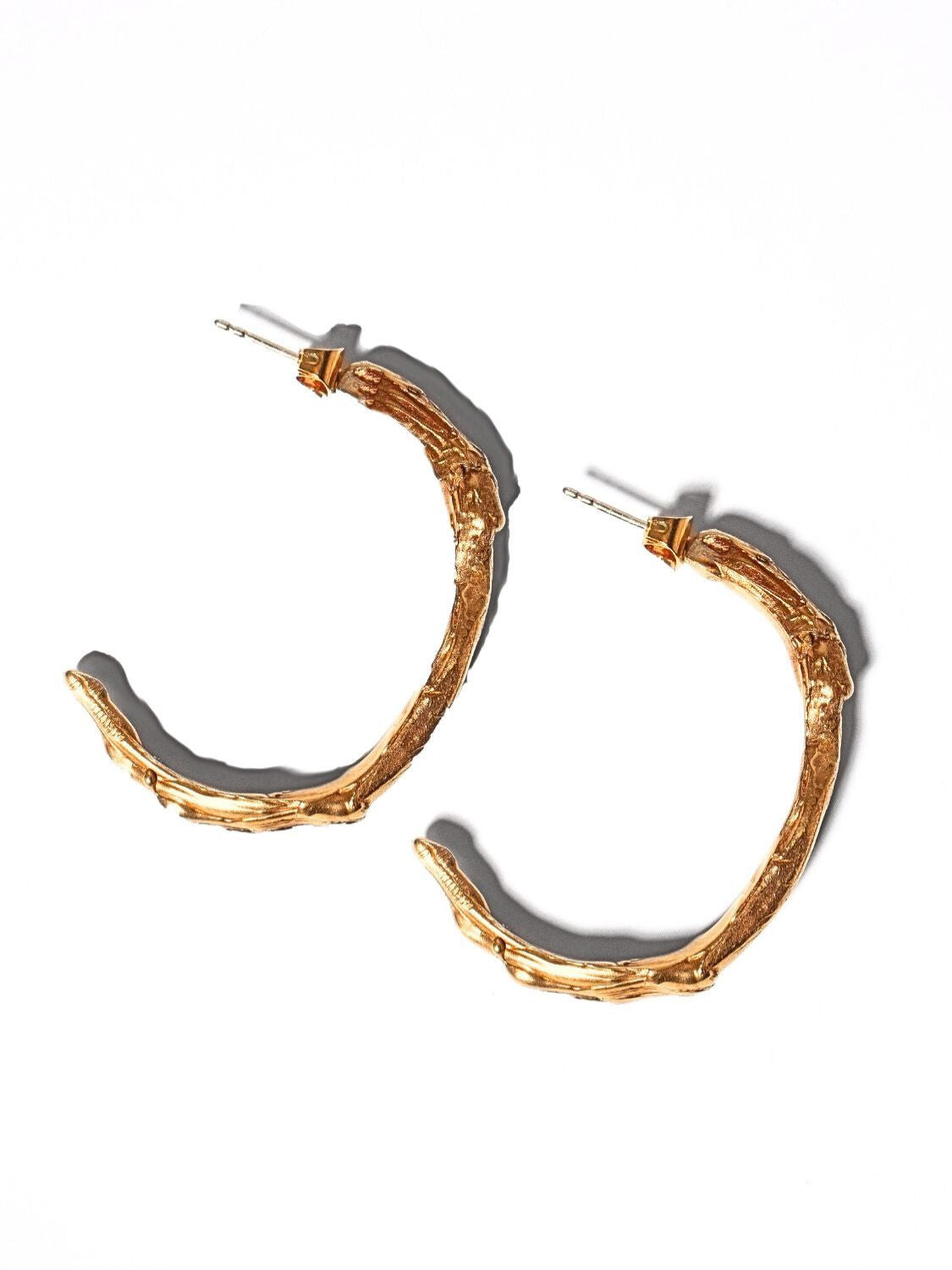 Gold goddess hoops on a light grey background | The Bow Jewelry