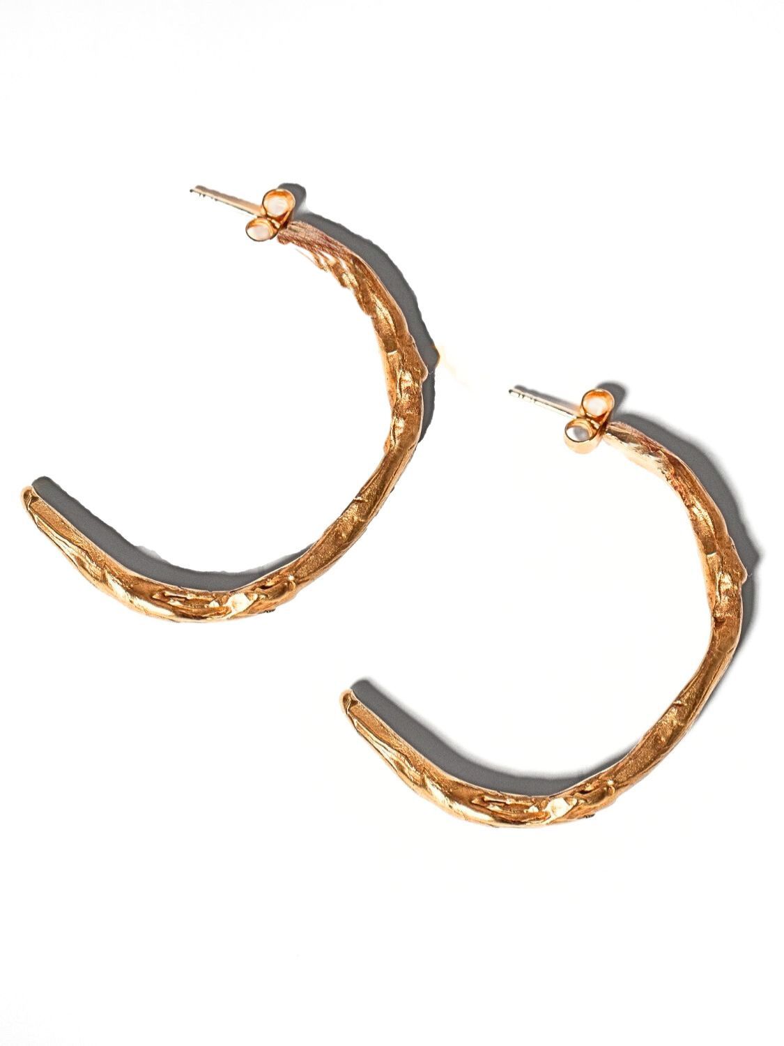 Gold Sculptural Goddess hoop earrings on a light grey background | The Bow Jewelry