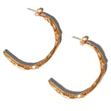 Gold Sculptural Goddess hoop earrings on a light grey background | The Bow Jewelry