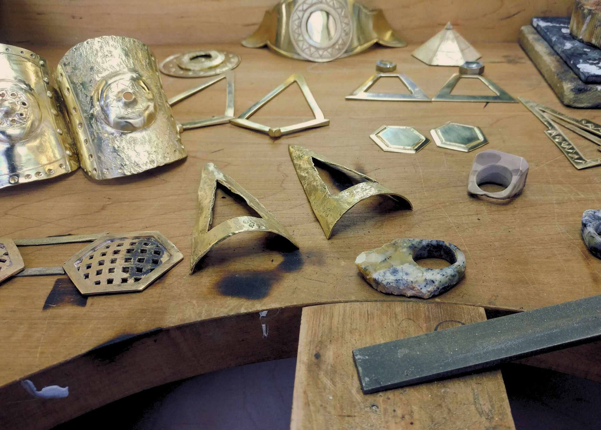 Collection of raw jewelry on jeweler bench | The Bow Jewelry 