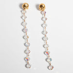 A pair of gold-plate earrings with intricate crystal embellishments and a vintage chandelier design.