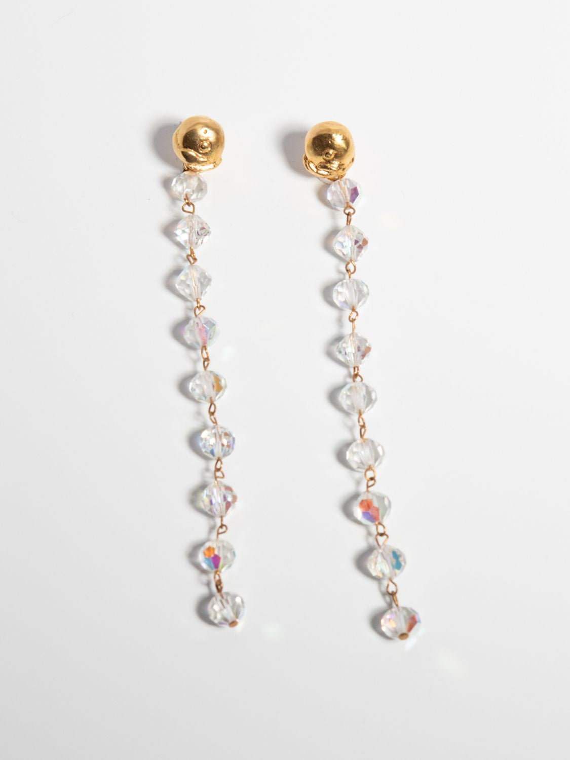 A pair of gold-plate earrings with intricate crystal embellishments and a vintage chandelier design.