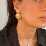 model wearing protector lion symbolic earrings | The Bow Jewelry