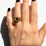 Gold ring with a emerald gemstone on a hand - The Bow Jewelry