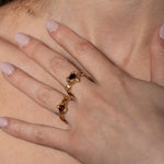 A model wearing gold-plated Heart shaped ring with a pear-shaped garnet in the center, set in a heart shape | The Bow Jewelry