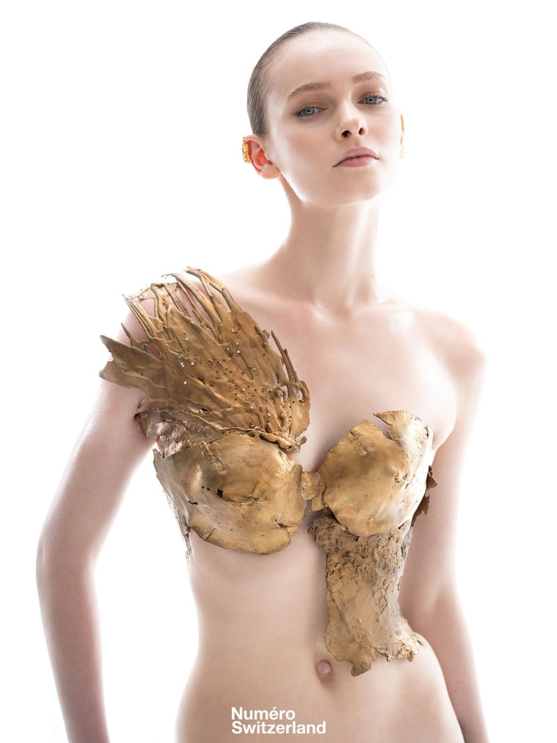 A model wearing sculptural, torn bustier |The Bow | Numéro Switzerland' Metal and Flesh Editorial Shoot.