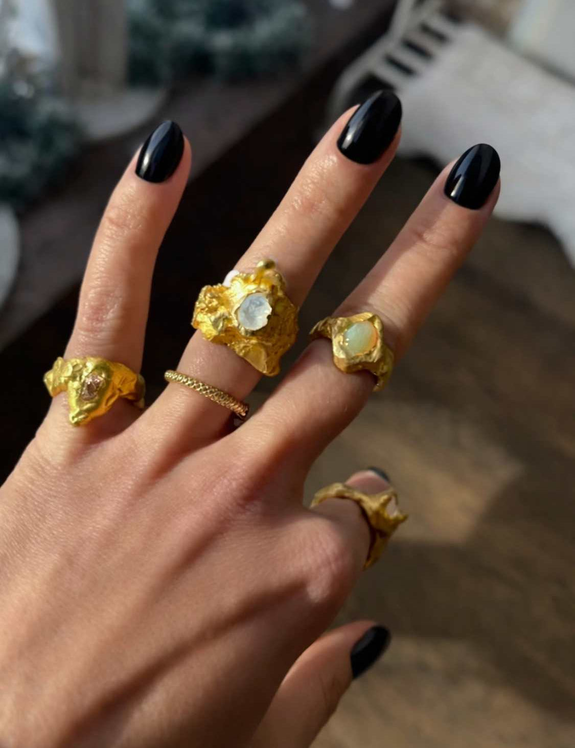 Close-up of a hand wearing a Nyx ring set with a moonstone |The Bow Jewelry