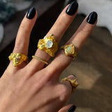 Close-up of a hand wearing a Nyx ring set with a moonstone |The Bow Jewelry