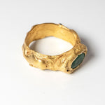 Gold ring with oval emerald on a white background  | The Bow Jewelry