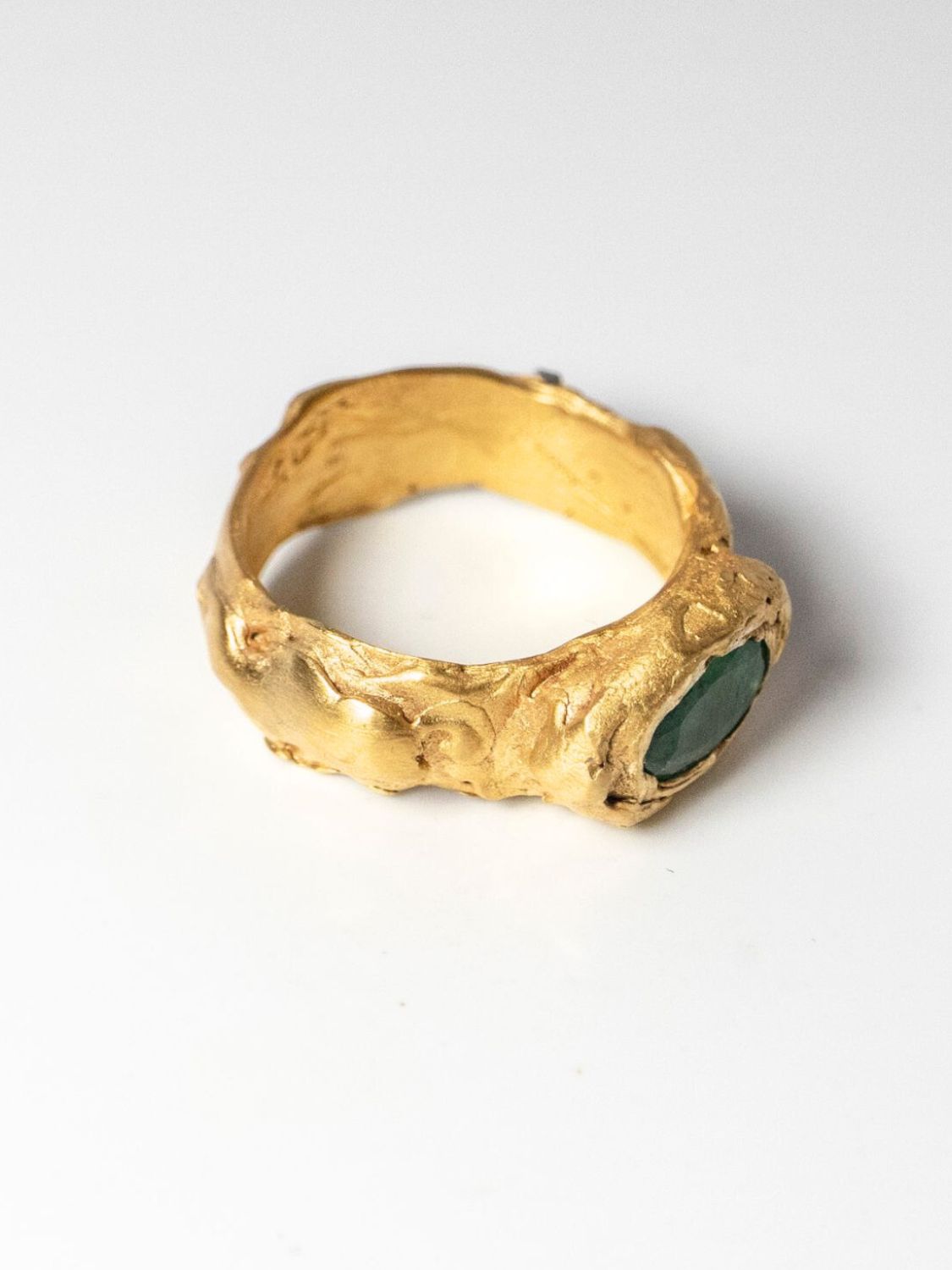 Gold ring with oval emerald on a white background  | The Bow Jewelry