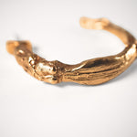 Gold goddess hoops on a light grey background