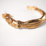 Gold goddess hoops on a light grey background